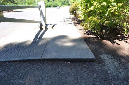 Sidewalk without transition ends at the park entrance – sidewalk drops onto driveway